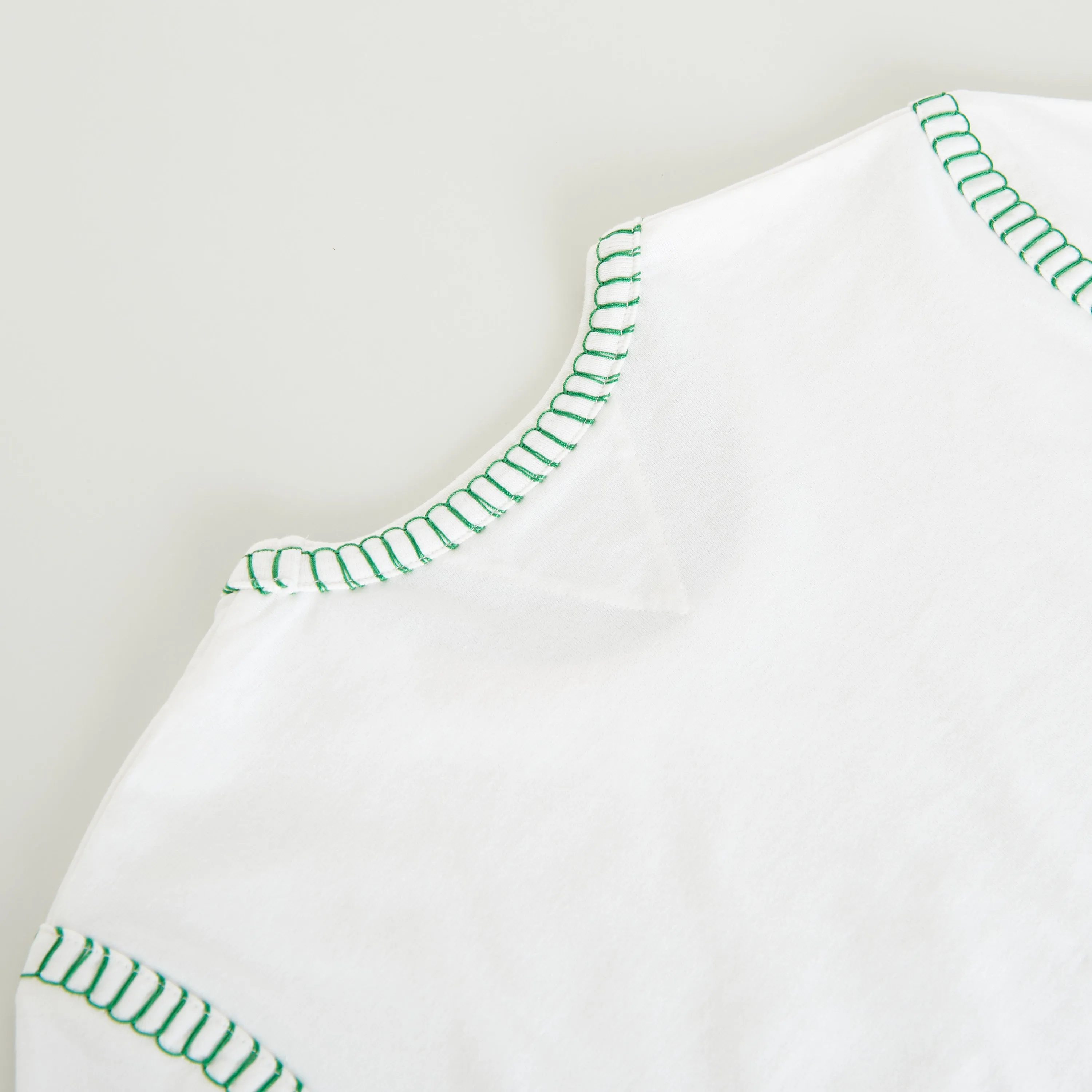 Overlock Tshirt In White Cotton & Green Stitch Detailing