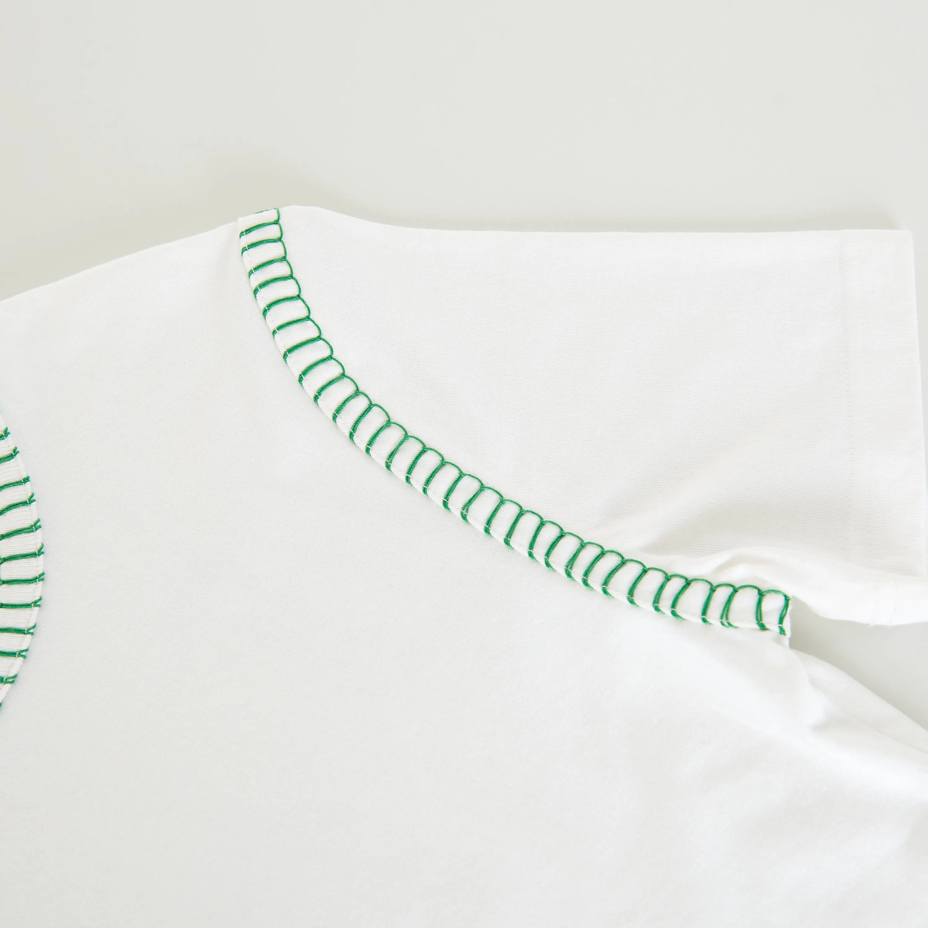 Overlock Tshirt In White Cotton & Green Stitch Detailing